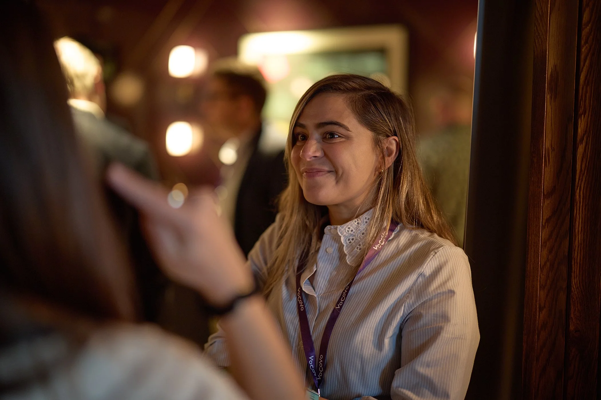A candid portrait of an attendee networking during the morning registration for a VoCoVo corporate summit in London.