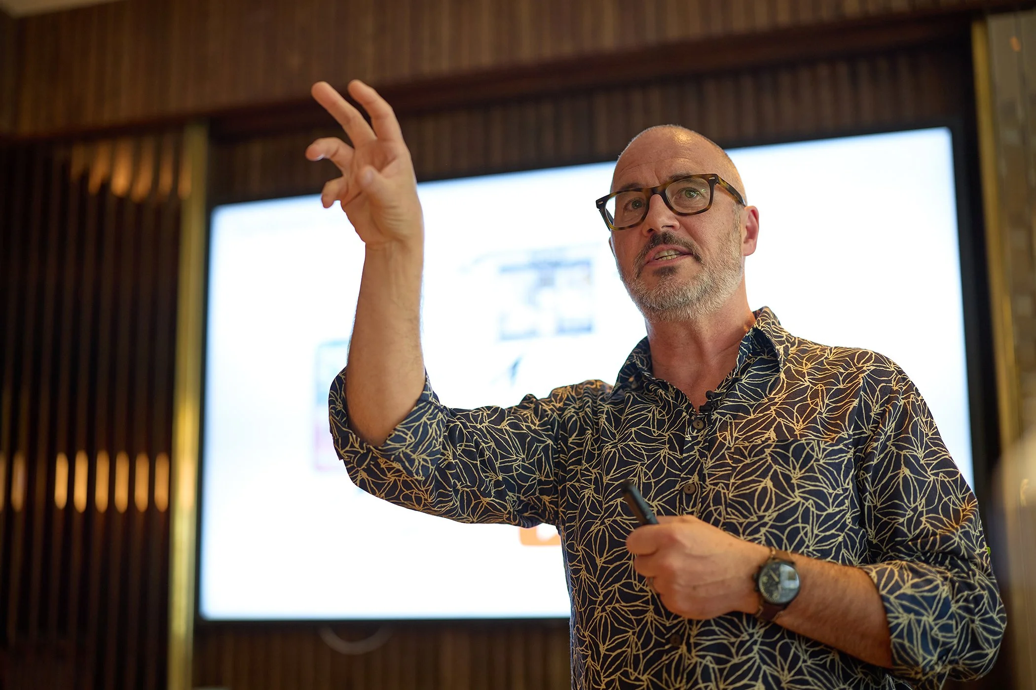 A keynote speaker discussing communications technology during the VoCoVo corporate summit in London.