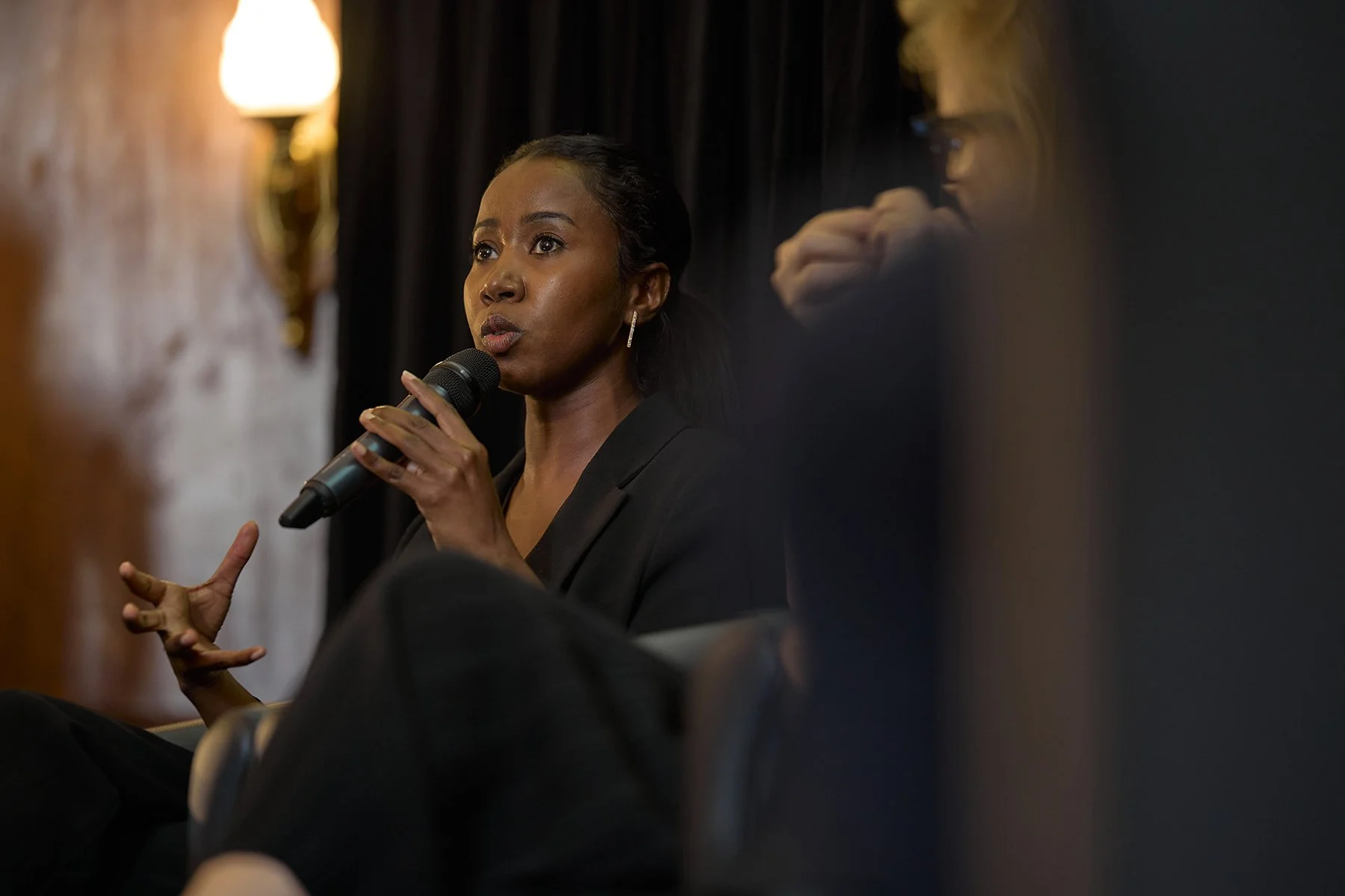 Candid photography of Dr. Rayan Altayeb, medical doctor and health economist, speaking on the Youthquake panel at the World Health Summit in London for authentic event storytelling.