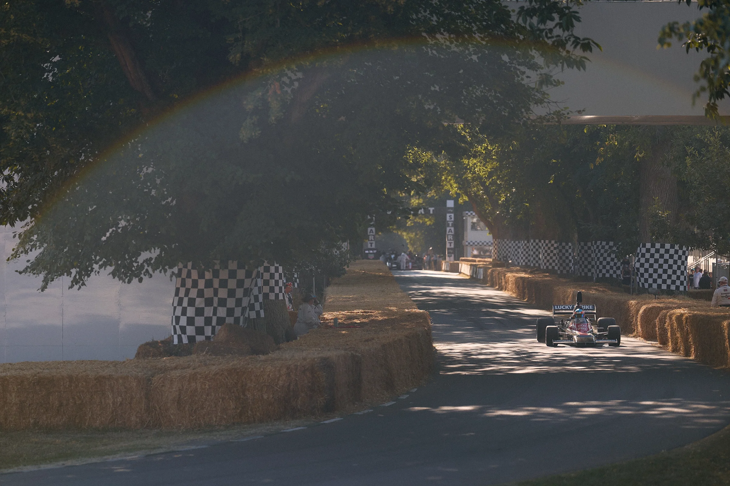 Lucky Strike Formula 1 car driving up the hill climb at the 2026 Goodwood Festival of Speed.