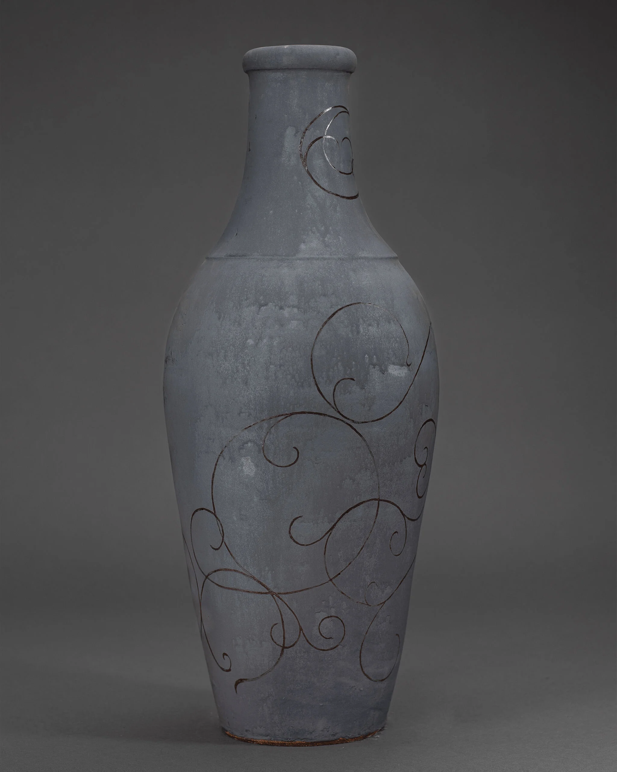 Gray ceramic vase adorned with abstract swirling line patterns
