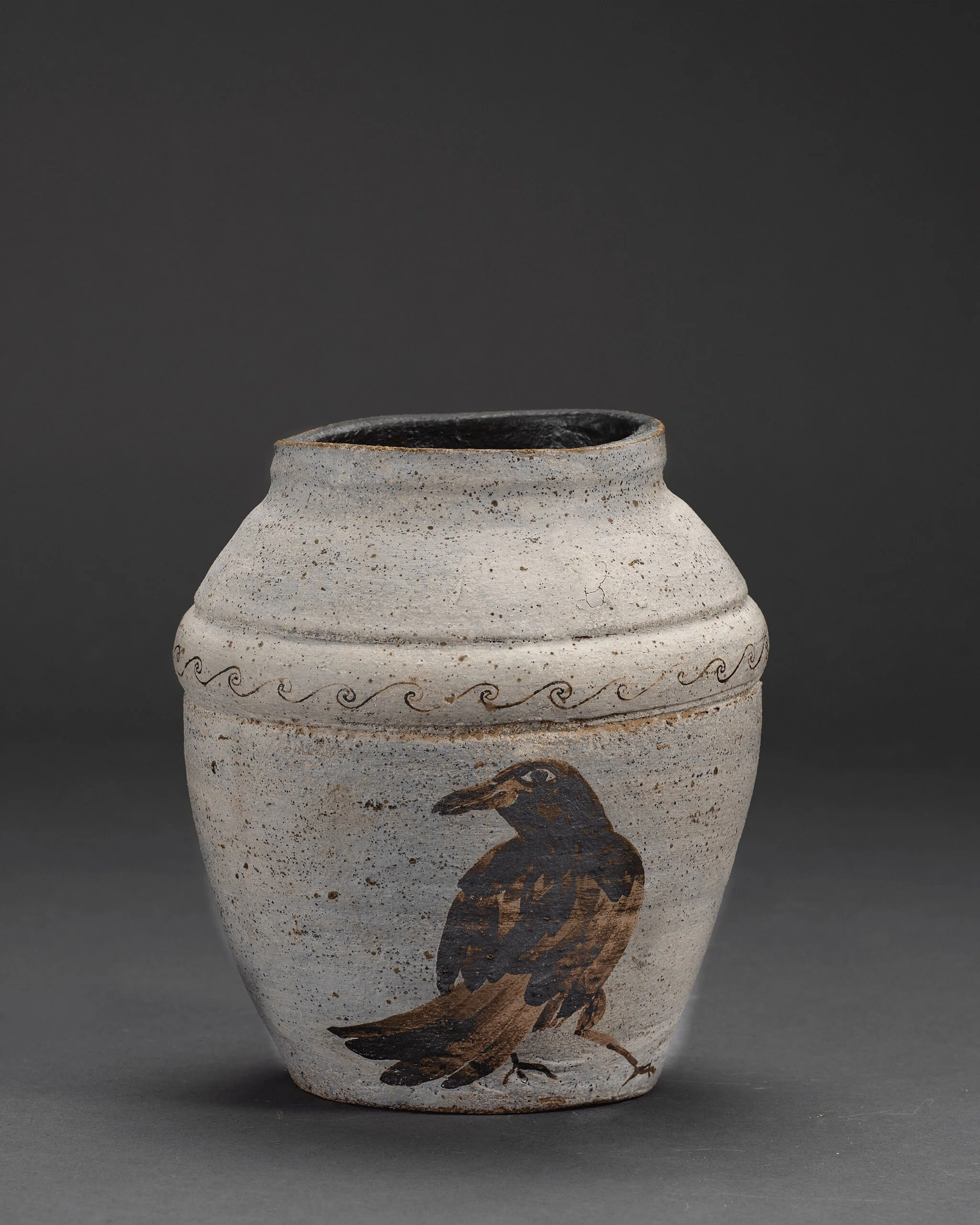 Handmade pottery piece highlighting cultural motifs and textured finish