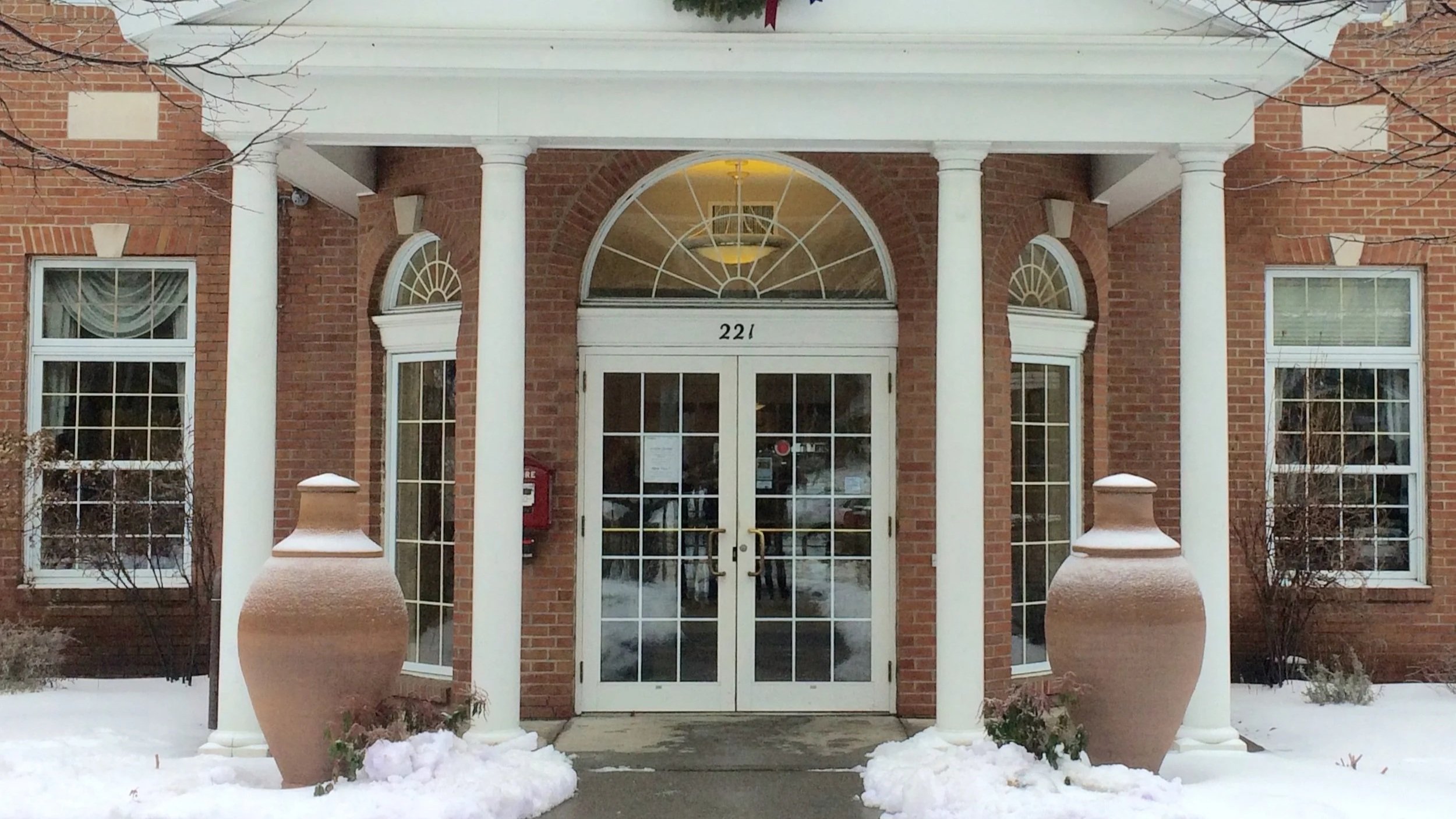 An image of a two vessels with a snow outside a building