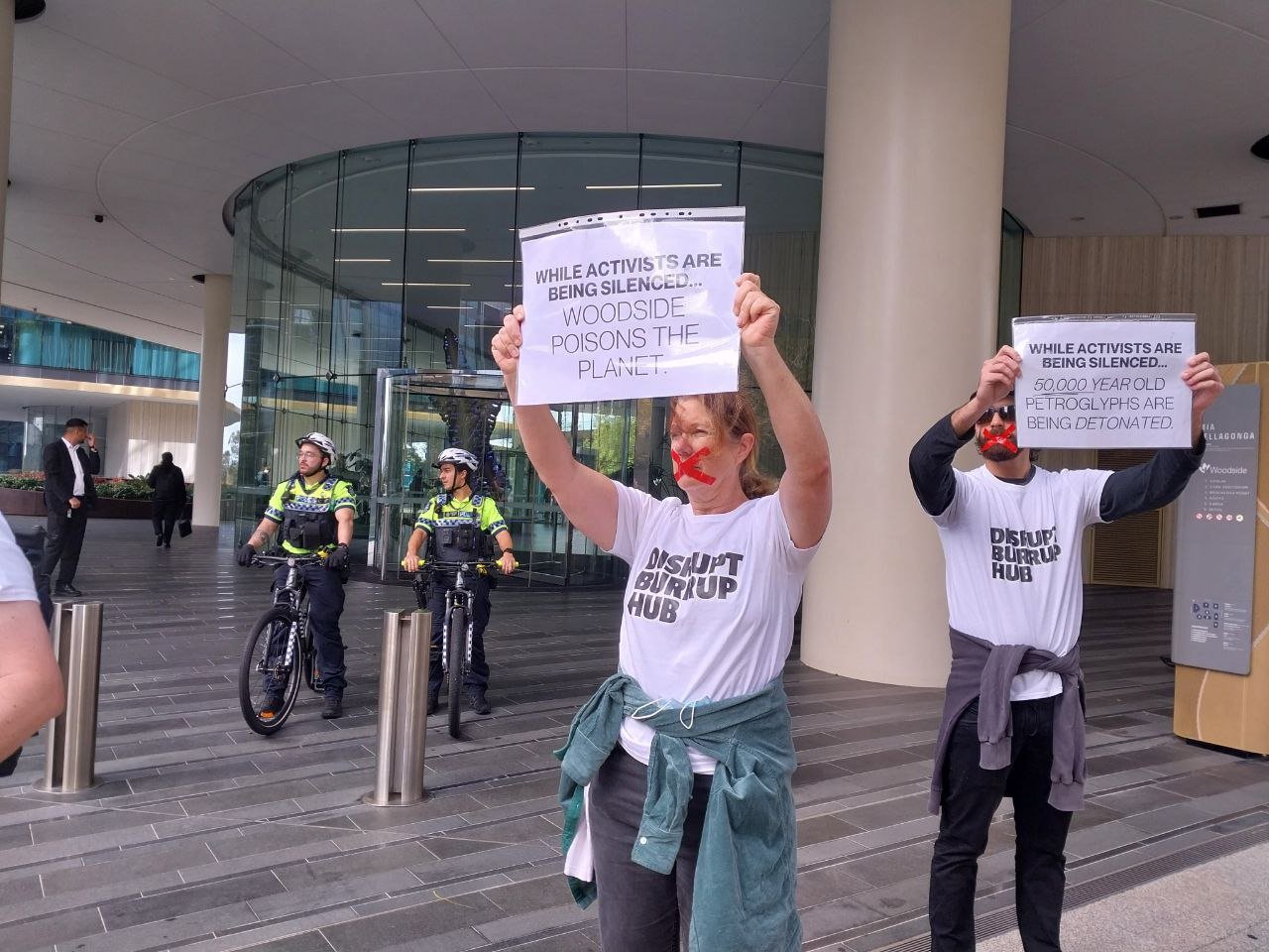 Disrupt Burrup Hub convenes silent protest outside Woodside HQ to call out VRO's and police repression. — DISRUPT BURRUP HUB