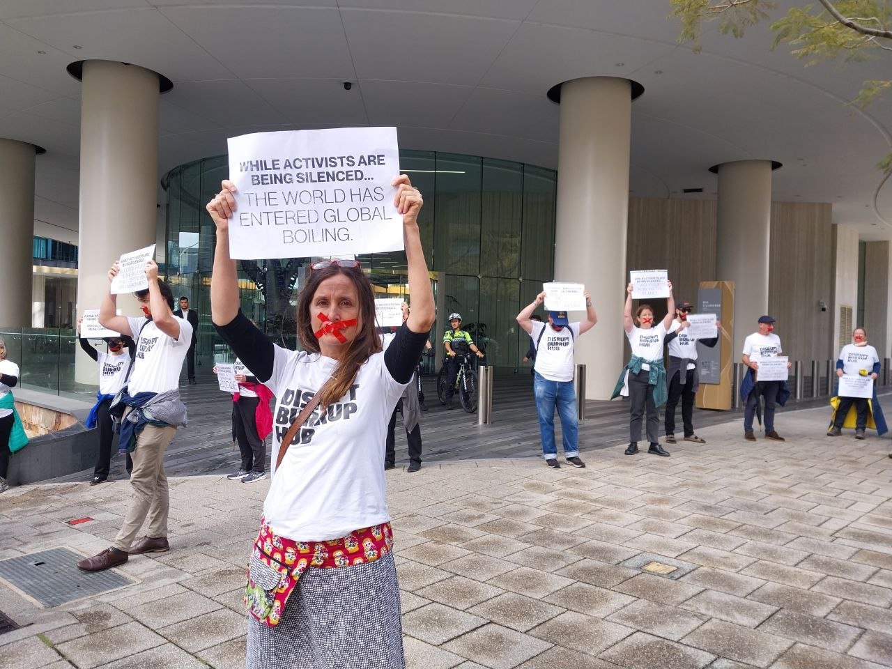 Disrupt Burrup Hub convenes silent protest outside Woodside HQ to call out  VRO's and police repression. — DISRUPT BURRUP HUB