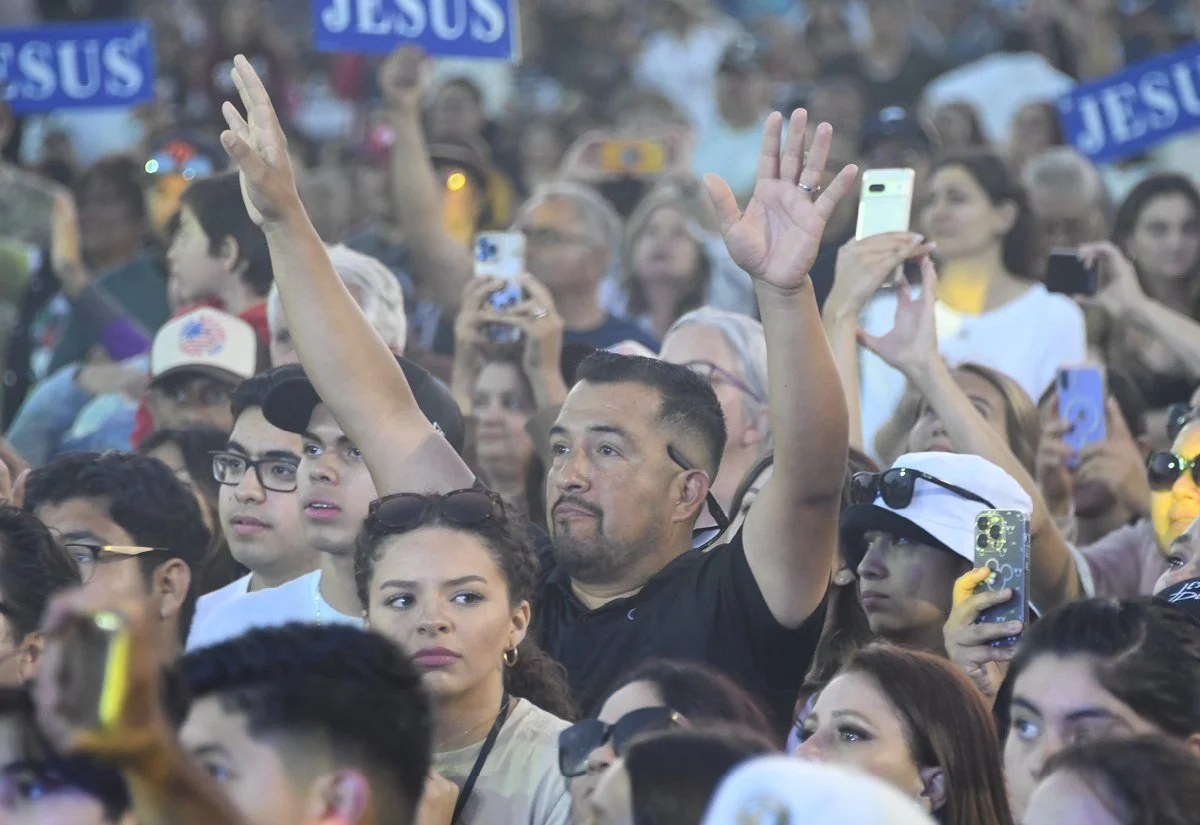   Arms lifted high exalting Jesus  