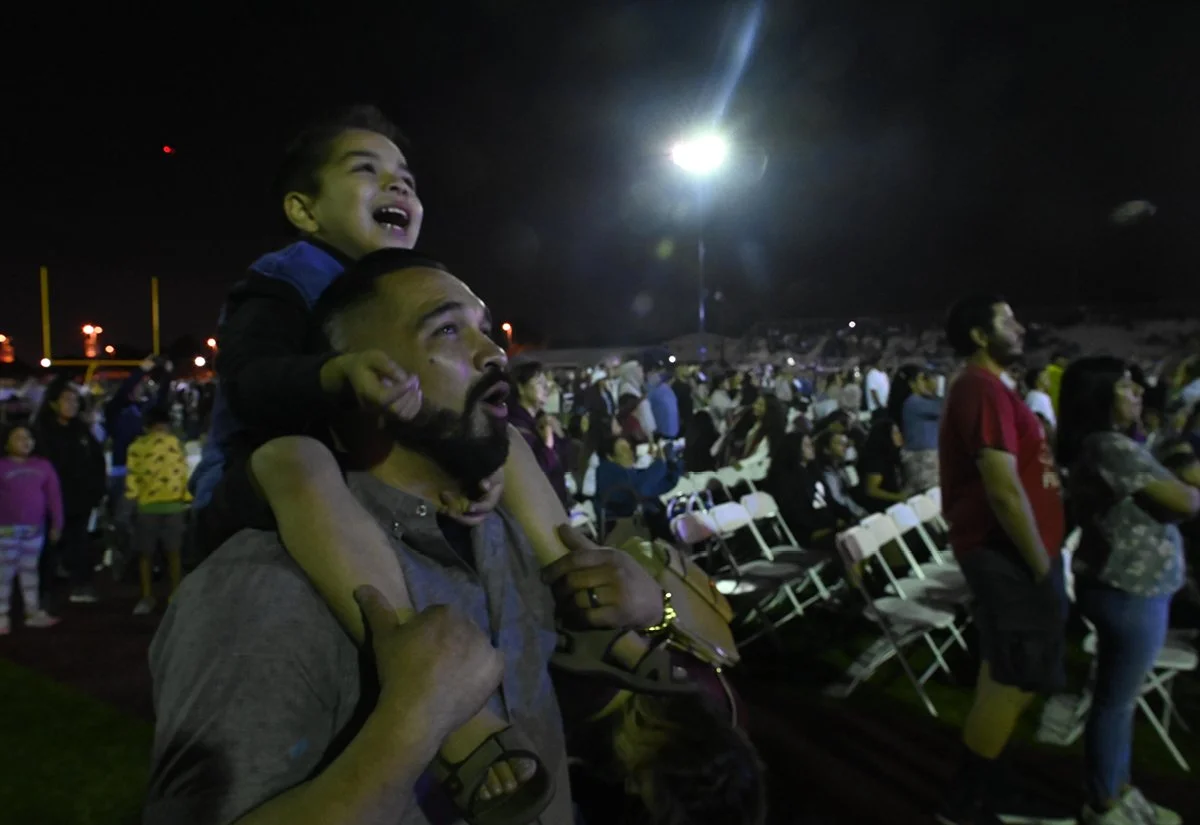   A delighted father &amp; son enjoy fireworks  