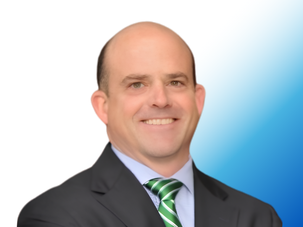 A smiling man in a business suit with a black jacket, white shirt, and green striped tie, posing against a background that fades from white to blue.