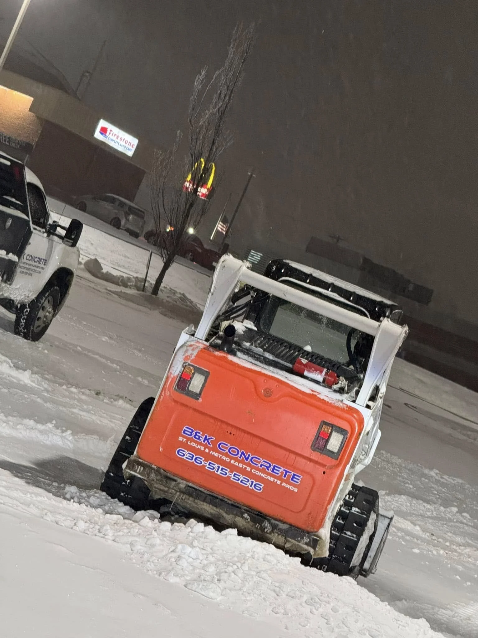 Snow pushing vehicle shoveling snow out of a parking lot