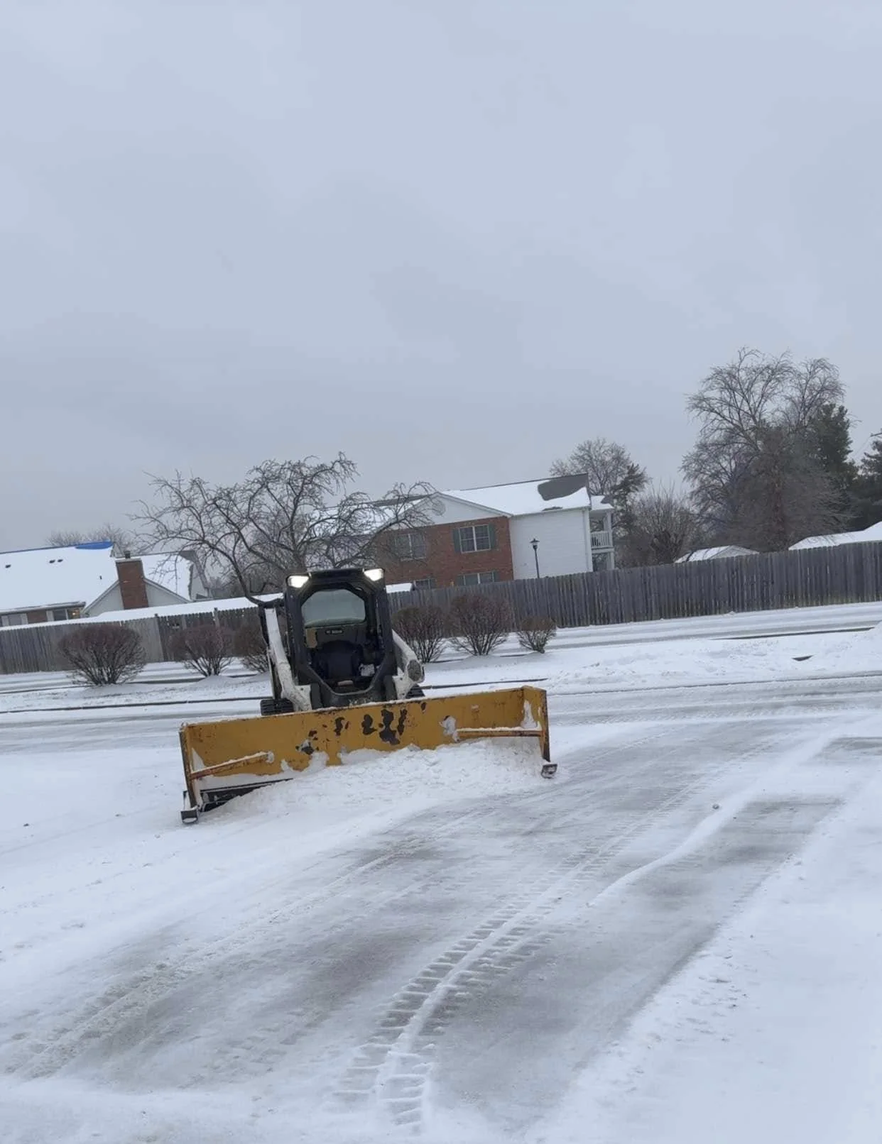 Snow plow pushing snow out of driveway
