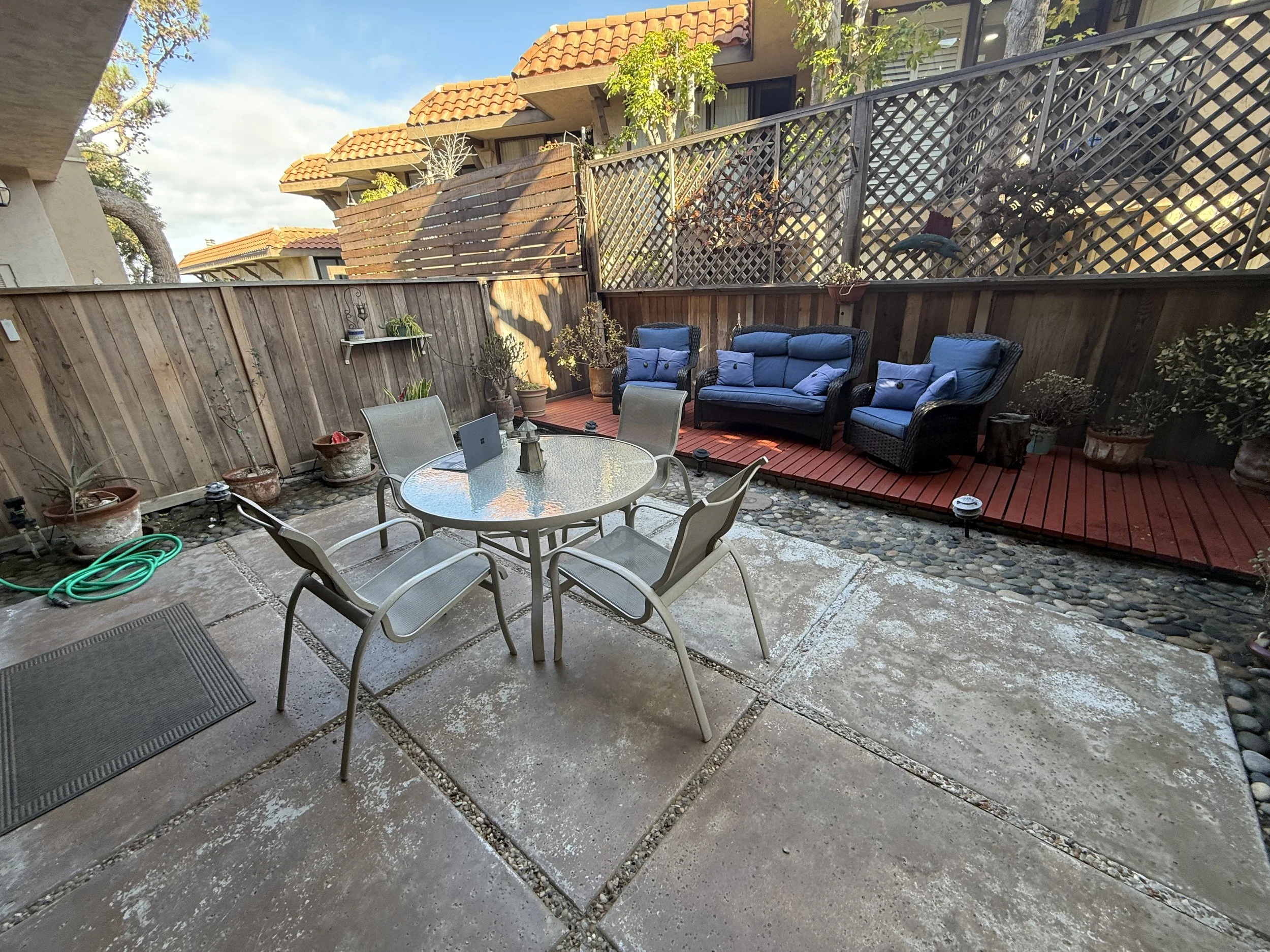 The private outdoor patio off the living room at our Solana Beach vacation rental—stocked with plenty of seating for dining al fresco or relaxing. The perfect place for your morning coffee or getting in the "flow" before the tide goes down. 