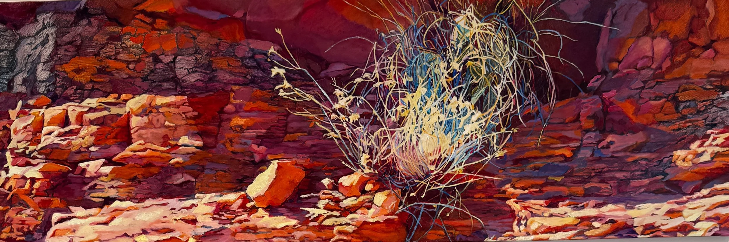 Painting of a desert landscape with reddish rocks and sparse dry vegetation, including a prominent desert shrub with thin, spindly branches.
