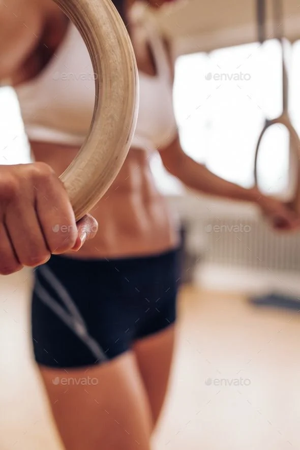 Woman training on gymnastic rings at Get A Grip in Bondi Junction