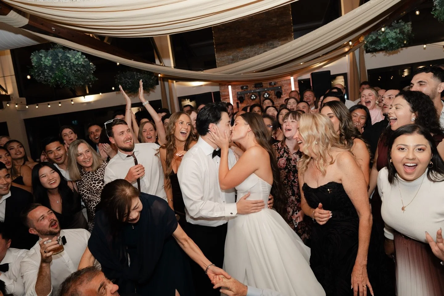 We talked about this photo before the wedding day.

Not because it was on a shot list.
Because it&rsquo;s the last still moment before everything moves.

Everyone crammed in.
The music already building.
Hayley and Andy in the middle of it all.

@marr