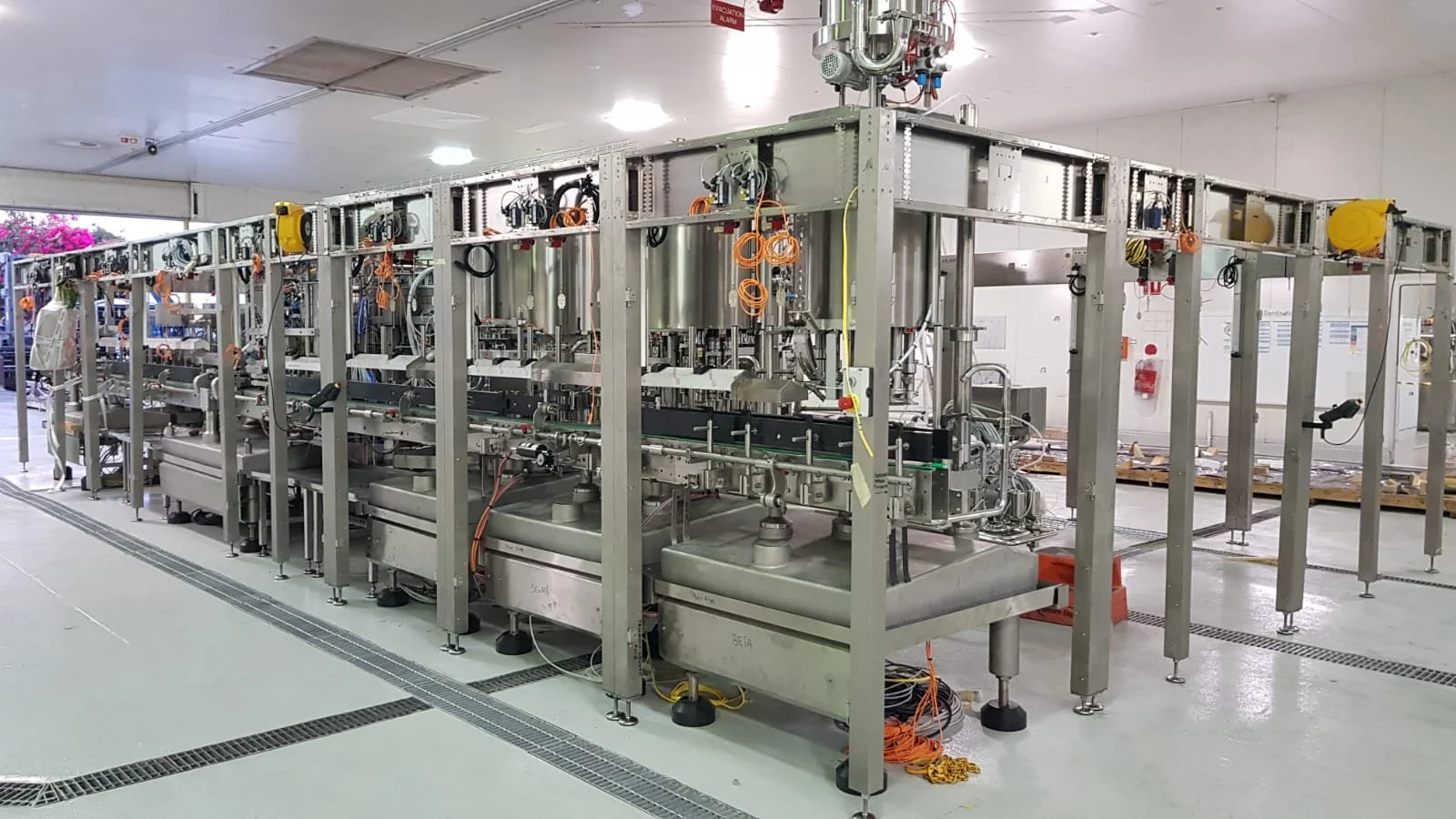 Proseq Industrial machinery setup with metal framework, pipes, and electrical connections in a factory or laboratory environment.