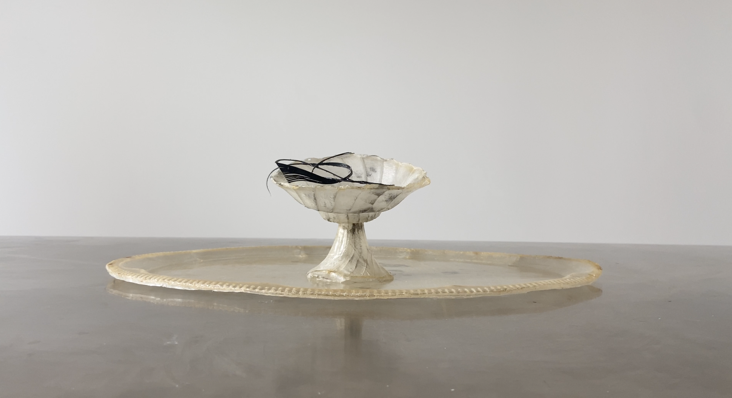Vessel I from OMEN by Janine Grosche, a translucent vessel and tray sculpture handcrafted from natural liquid latex.