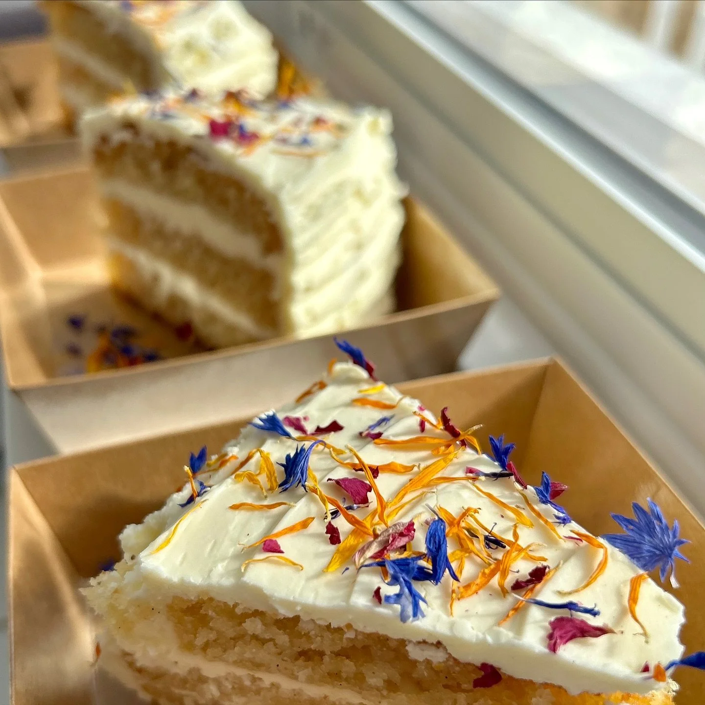 Today we have a freshly baked Gluten-Free Vanilla Cake 🍰 with white chocolate frosting and our edible crushed floral confetti 🪻🌸🌼.
Also on the menu: Carrot Cake 🥕 and Chocolate Chip &amp; Cranberry Oatmeal Cookies 🍪. Find us at 11186 Peggy&rsqu