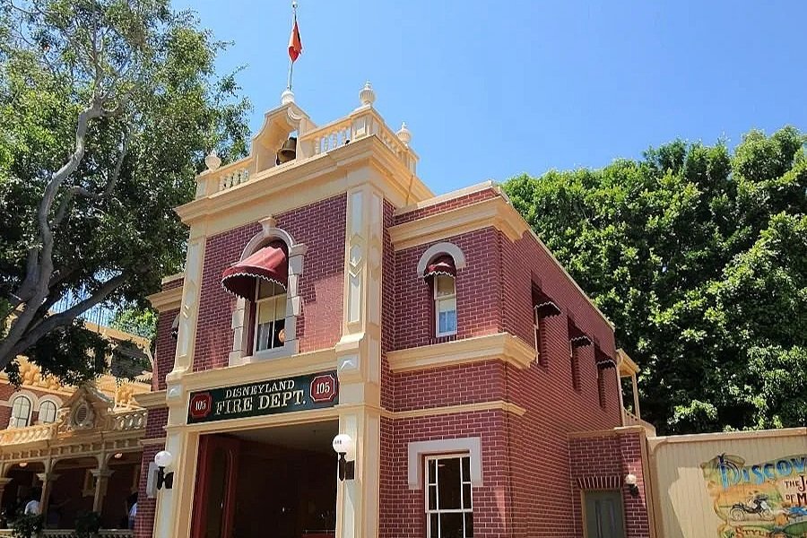A picture of the fire house on main street in Disneyland Calfornia. A brick building with white trim. The top floor was Walt Disney's apartment.
