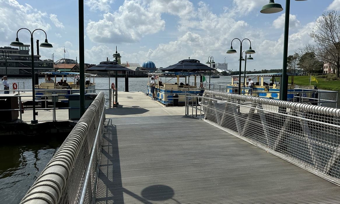 A photo of the boat dock at Disney Springs. You can see multiple boats at the end of the ramp that take you to Port Orleans, Old Key West, and Saratoga Springs, and hopefully on to Hollywood Studios.