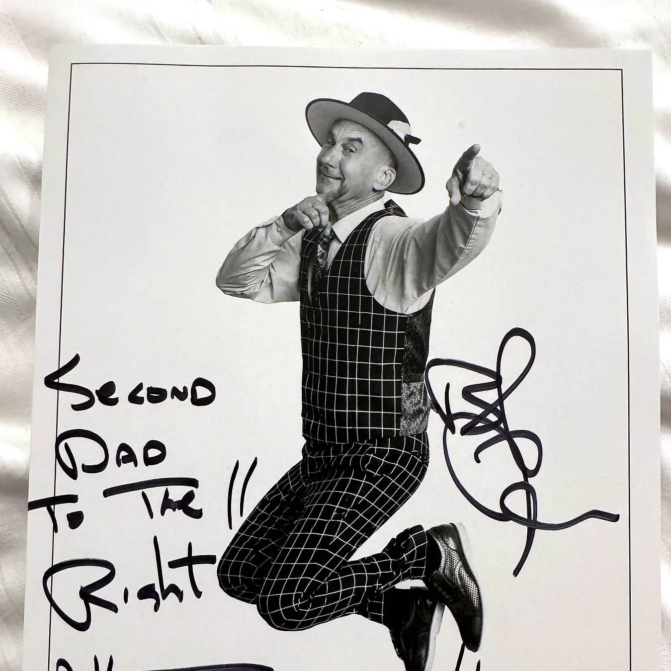 a photo of Yehaa bob in black and white jumping and pointing. The photo has an autograph made out to second dad to the right.