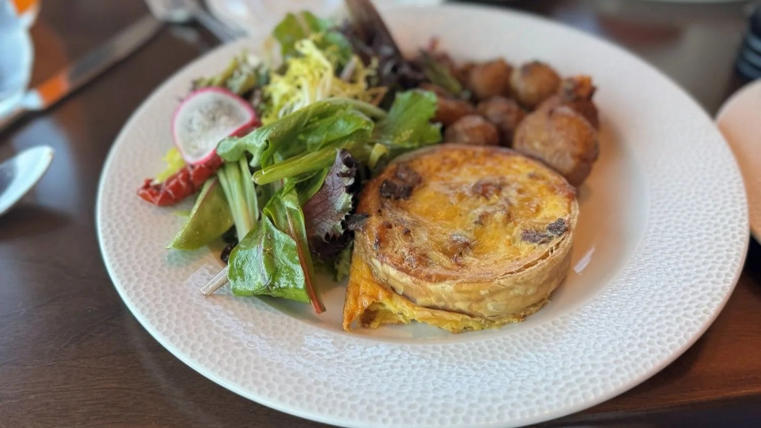 A quiche with greens and potatoes, one of the entrees at Topolino's Terrace character breakfast at Disney World.