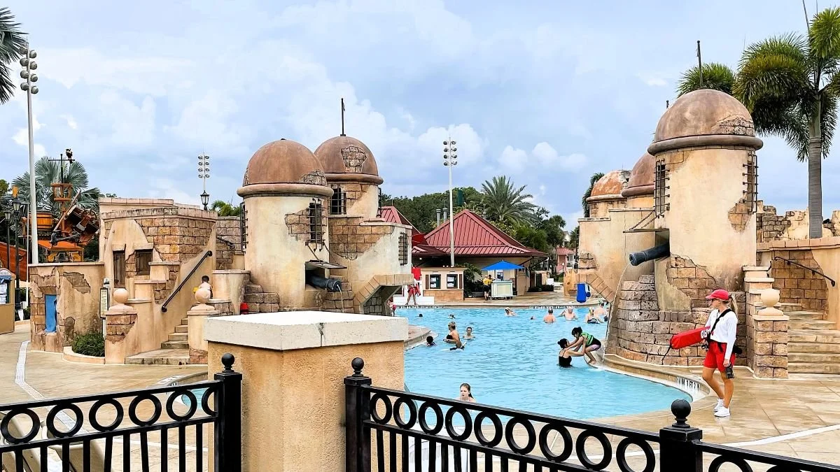 The Fuentes de Morro pool at Caribbean beach. Several Spanish fortress turrets create water slides and water features for the pool at this Moderate disney resort.