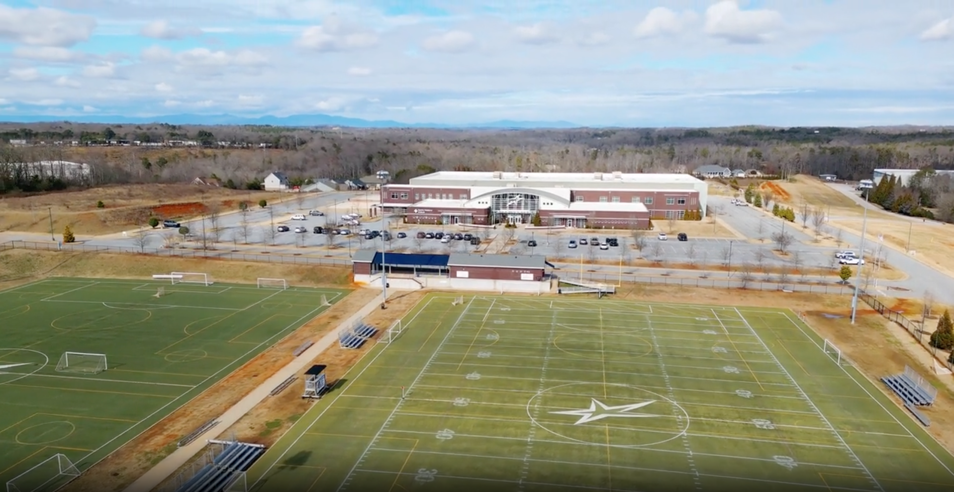 blank / decorative image of the school and field.png