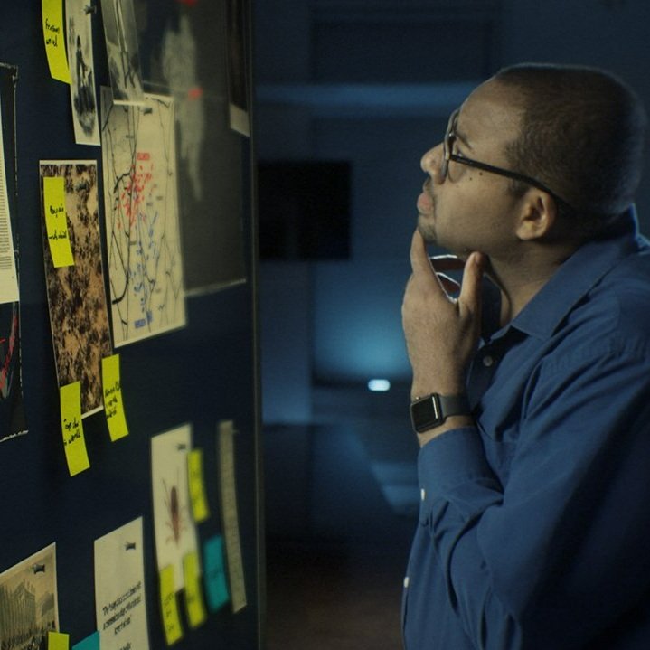 2.+Contributor+Marcus+Harshaw+looking+at+the+evidence+board.+EP1.jpg
