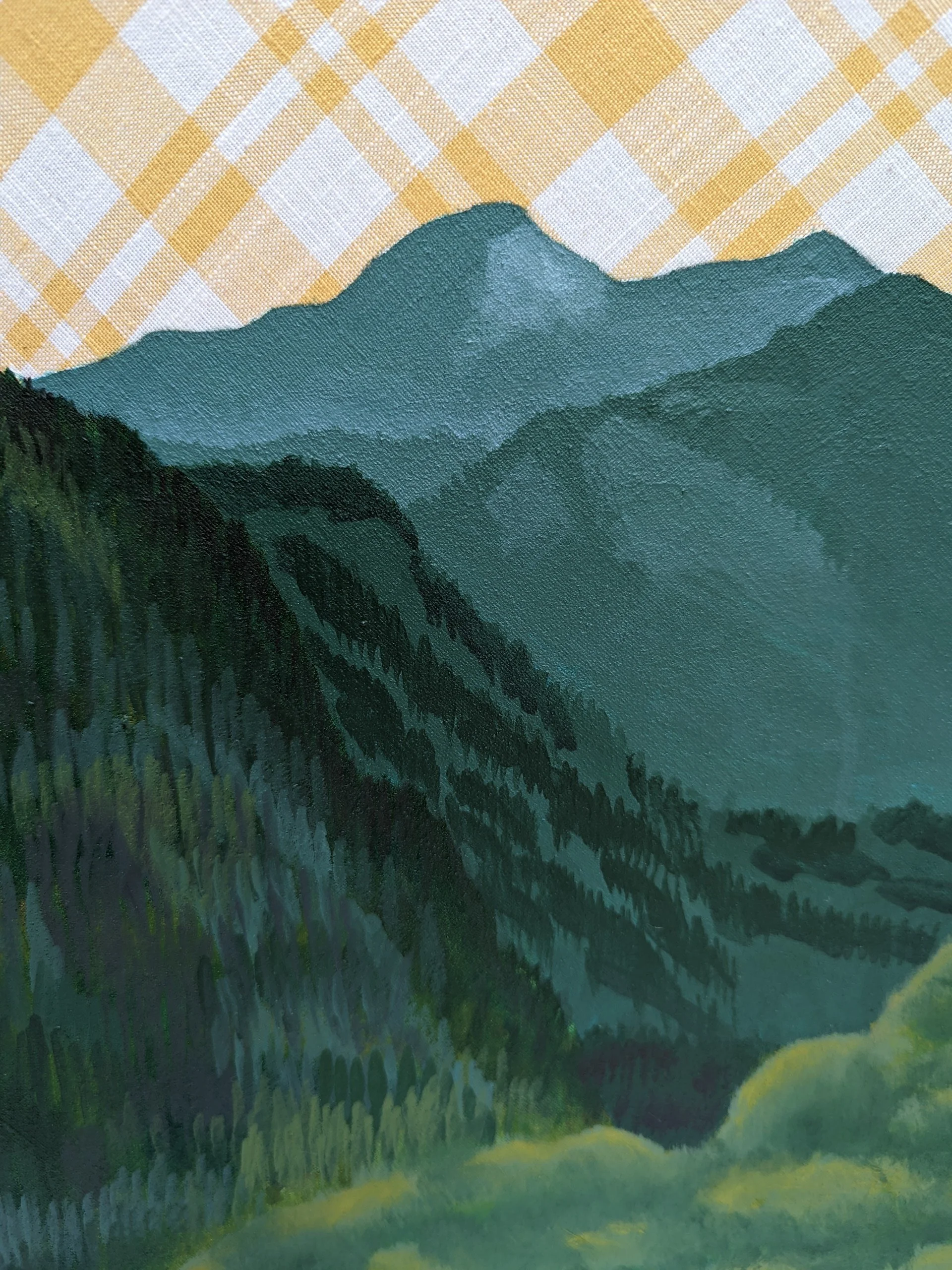 A cropped detail view of a landscape painting. The sky is the fabric the artwork is  painted on, a yellow and white plaid material. Green mountains at different distances.