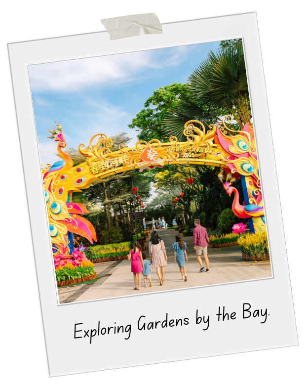 Family walking into a colorful garden entrance with dragon sculptures near a park by the bay.