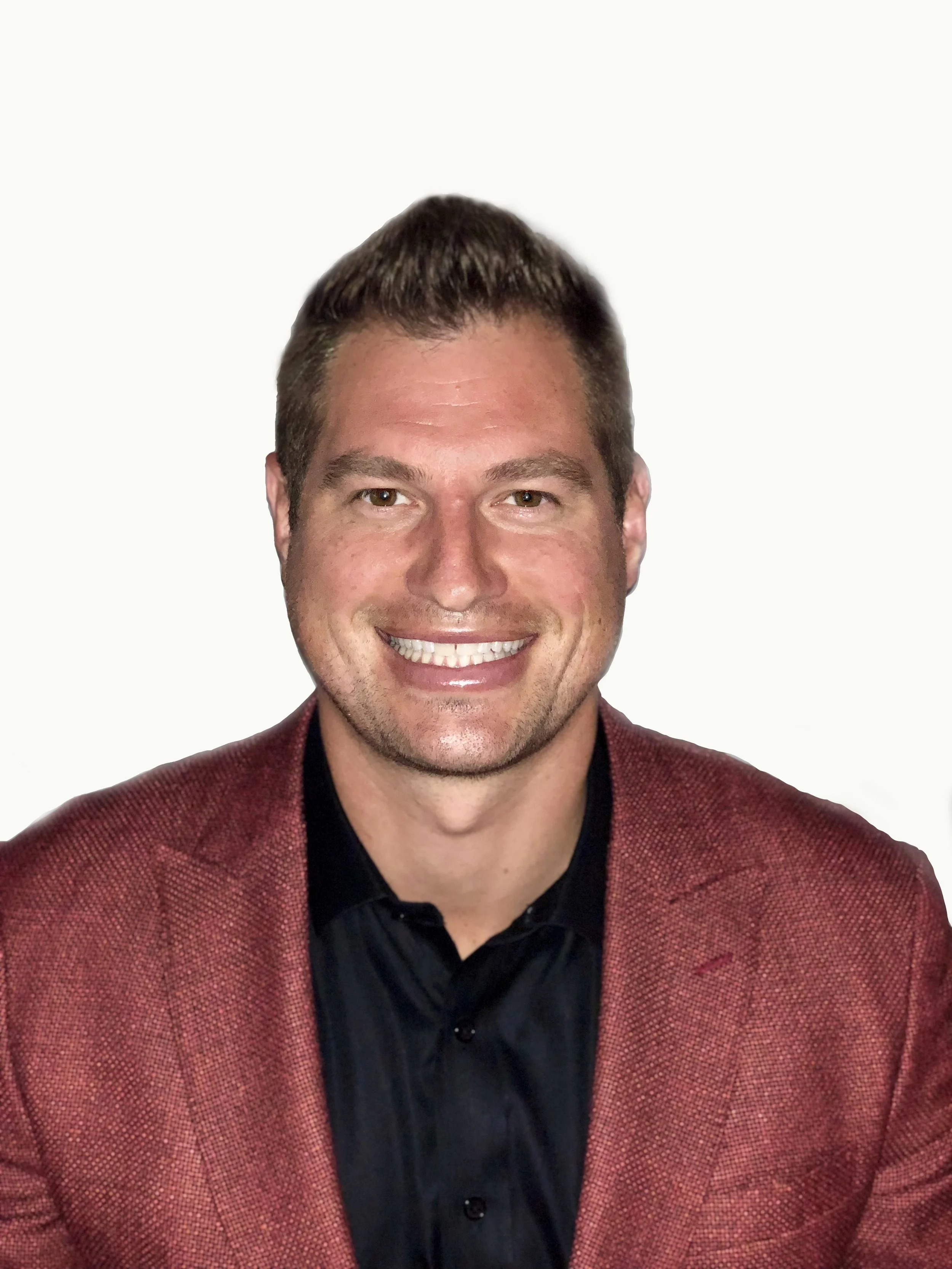 A smiling man with short brown hair and brown eyes, wearing a dark shirt and a red blazer, against a plain white background.