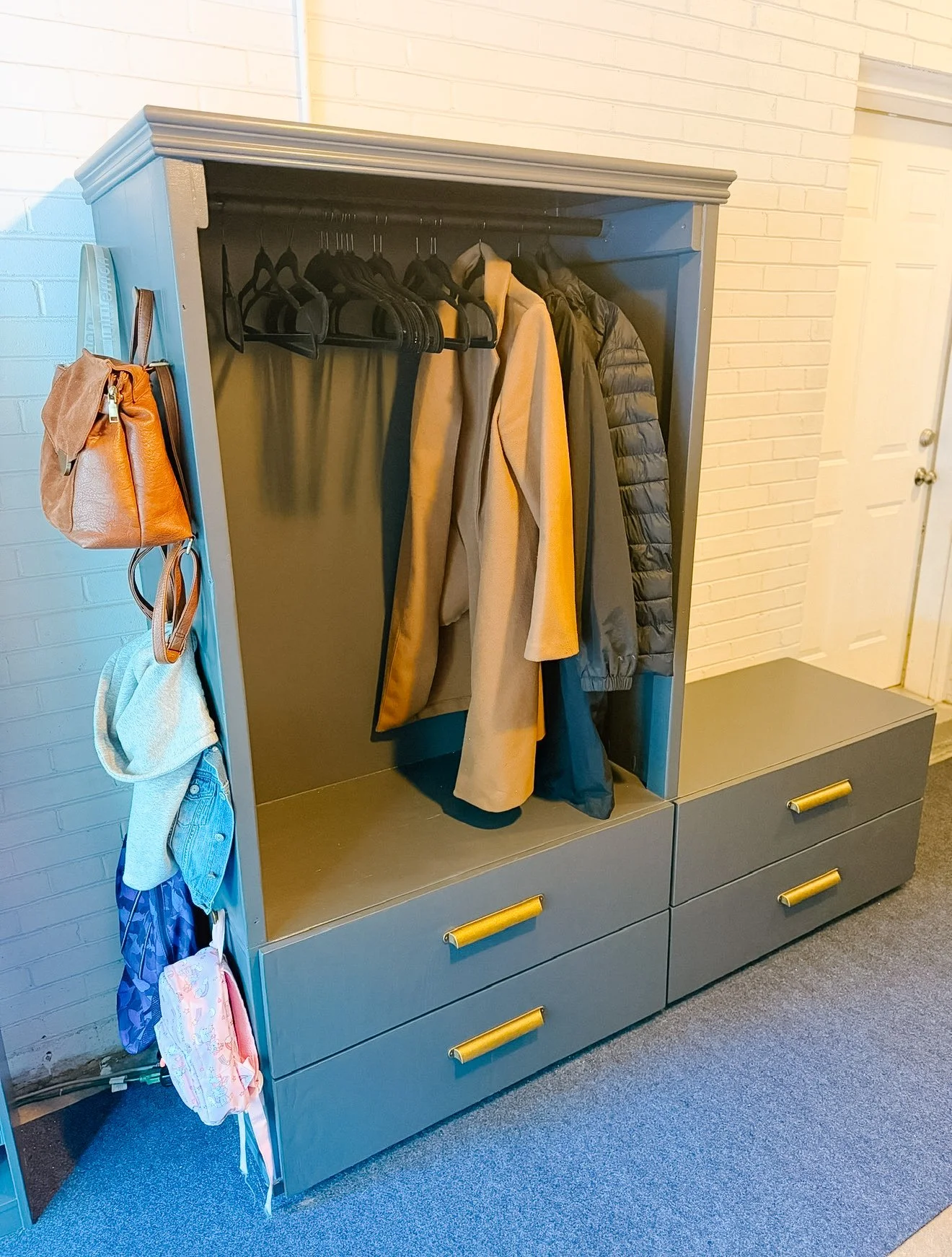 Custom built drop zone with coat hooks and drawer storage by Lindsey Lauten — designed and built in the Chicago area as part of a full home transformation project.