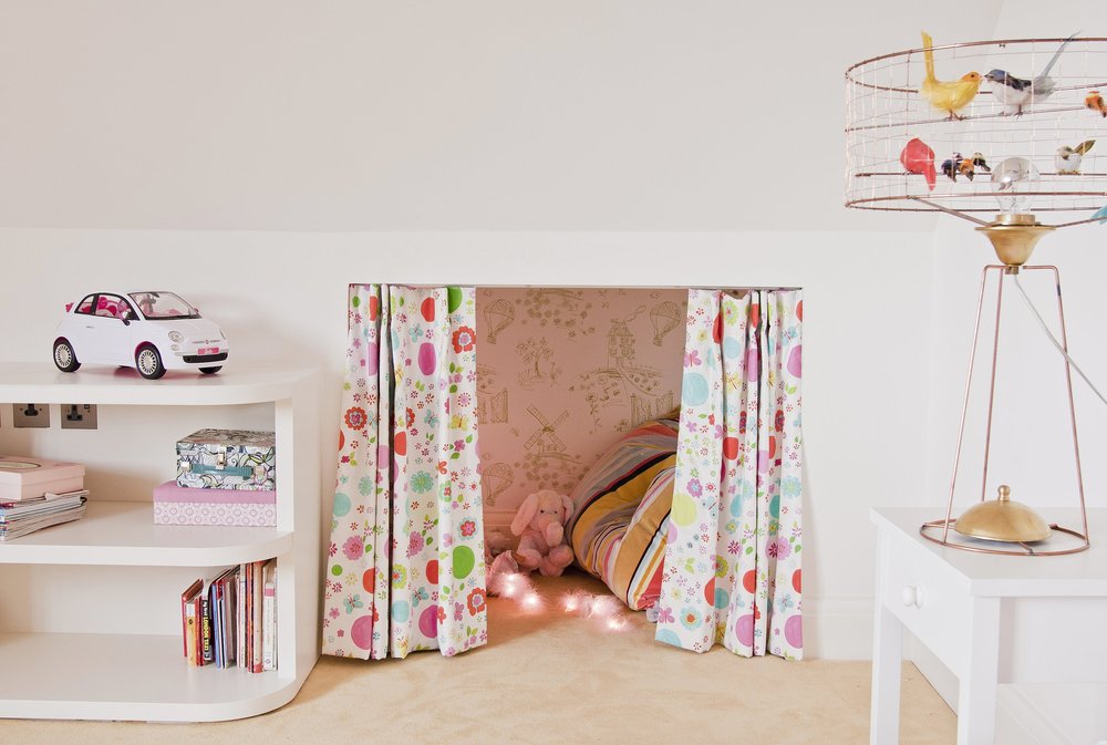  secret hideaway area and puppet show space with peel and stick tree wallpaper created a dreamlike childrens room in North London by Susan Knof  
