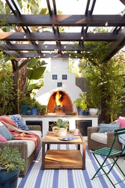 Outdoor fireside oasis with colorful cushions and white seating