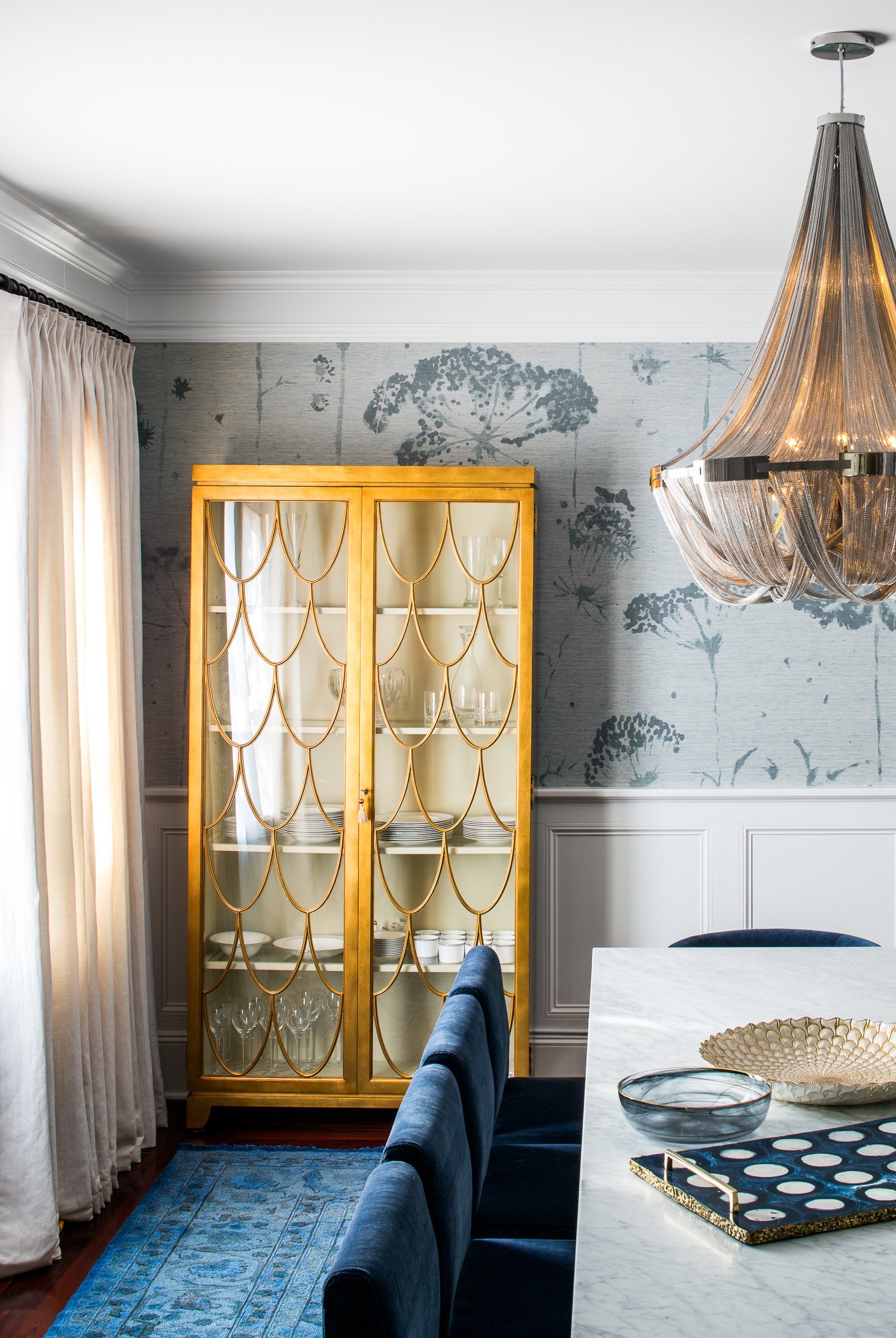 KNOF design creates a beautiful blue dining room with metallic accents