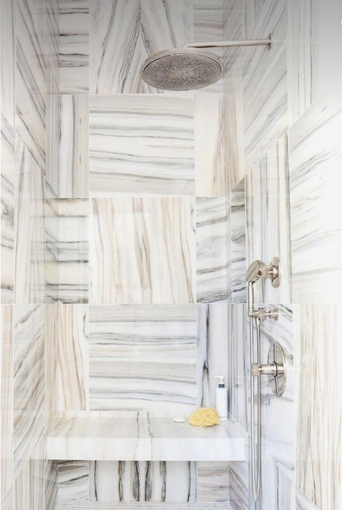 quarter turn marble tiles in enclosed shower stall with large ceiling mounted overhead shower 