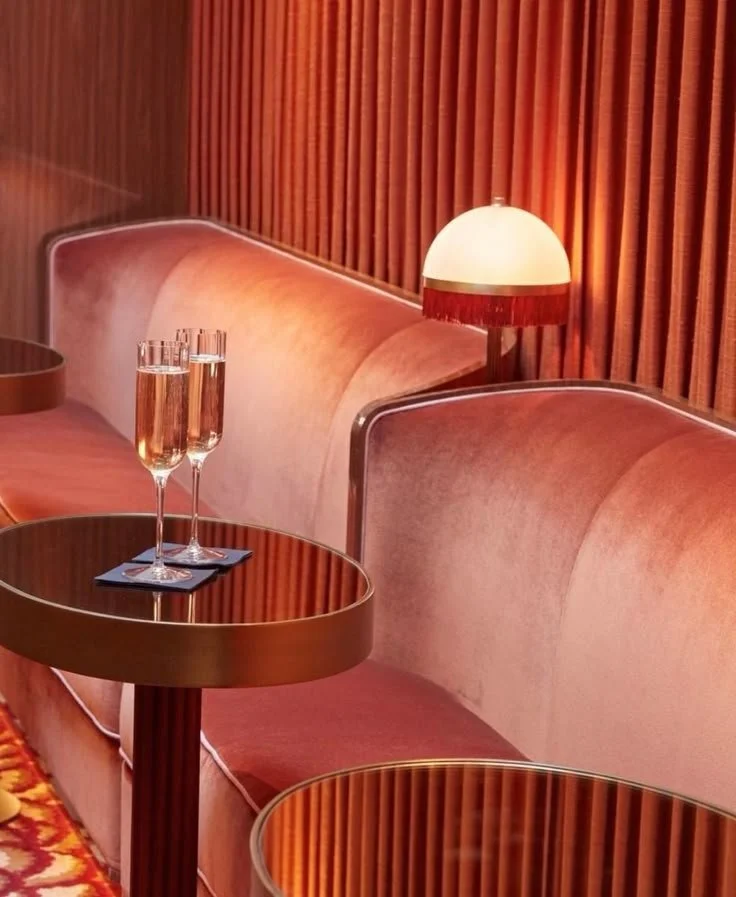 Curved Banquette with Ambient Lighting and Brass Table