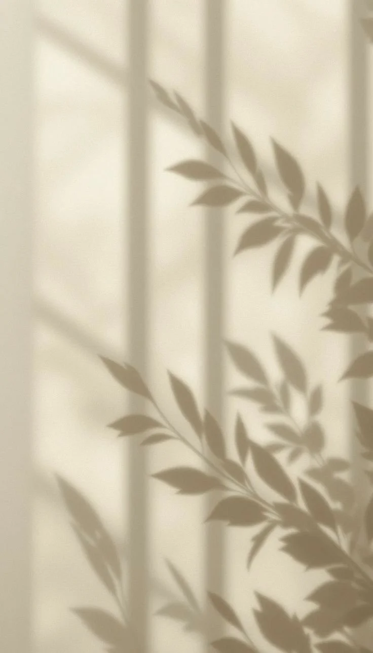 Light casting floral patterning on a white washed wall