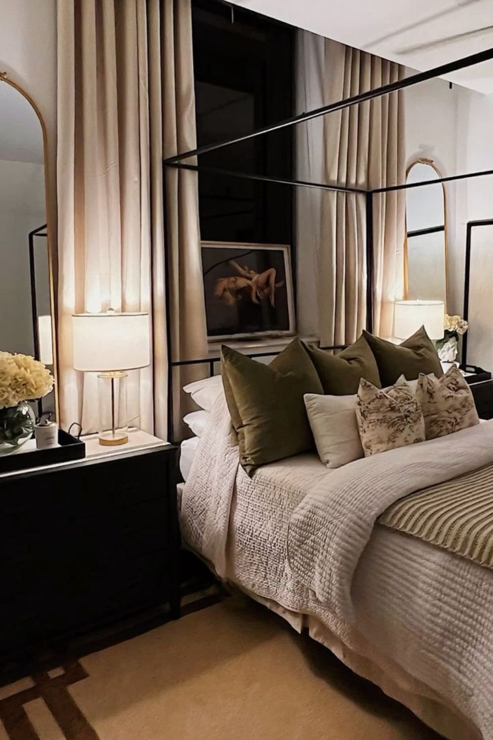 Elegant luxury master bedroom featuring a black canopy bed, tall drapery panels, and soft layered textures