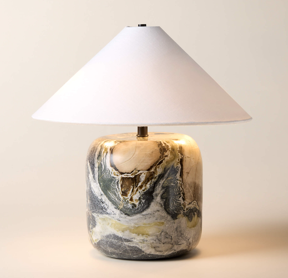 Mini marble table lamp by Melbourne-based design studio VUUE pairs clean lines with an elevated mix of materials. Carved from a solid piece of floral jade marble, the base is topped with a crisp white linen shade to cast a soft glow. The marble's bol