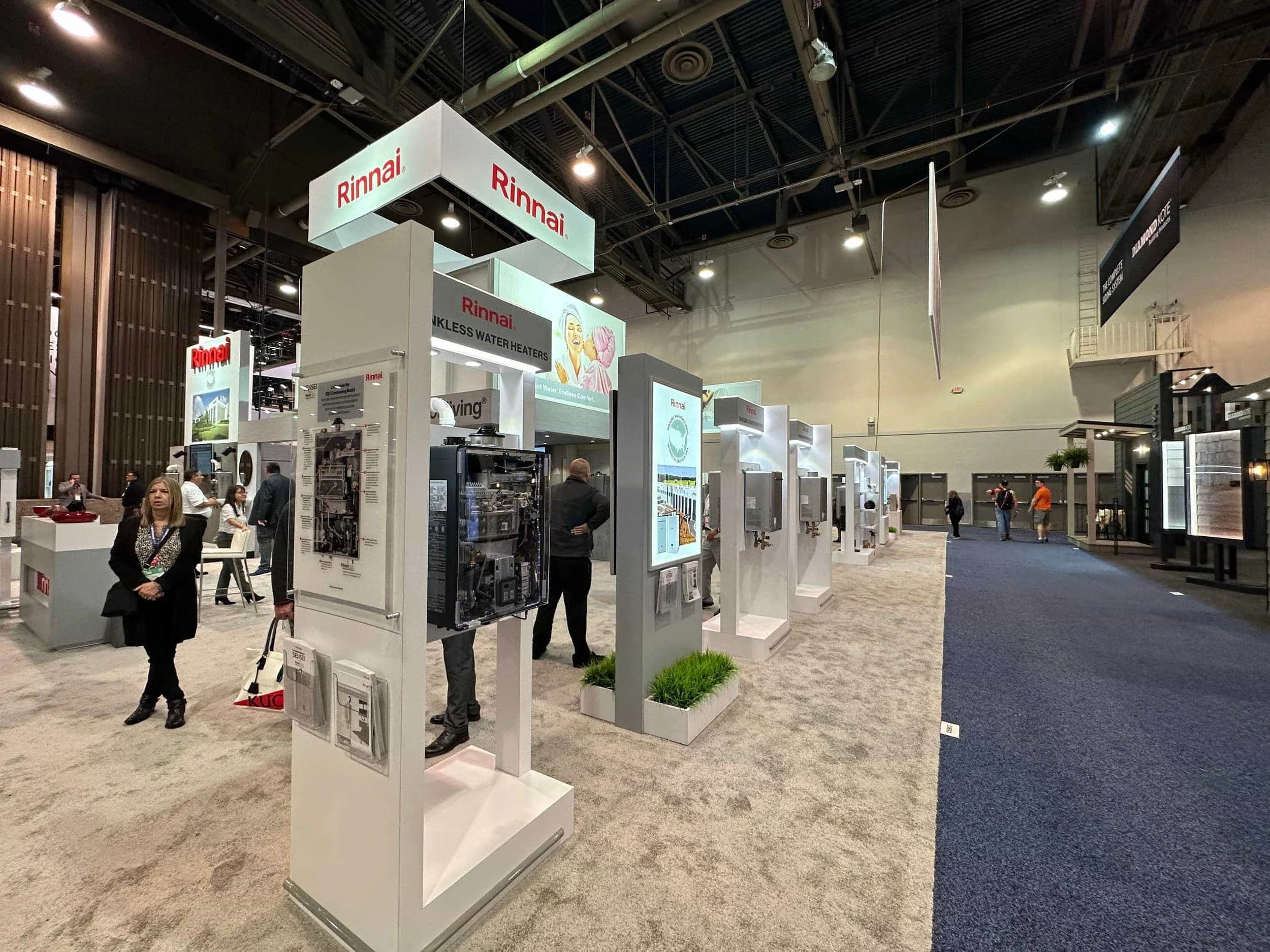 Rinnai tankless water heater displays and product kiosks at a convention center trade show booth