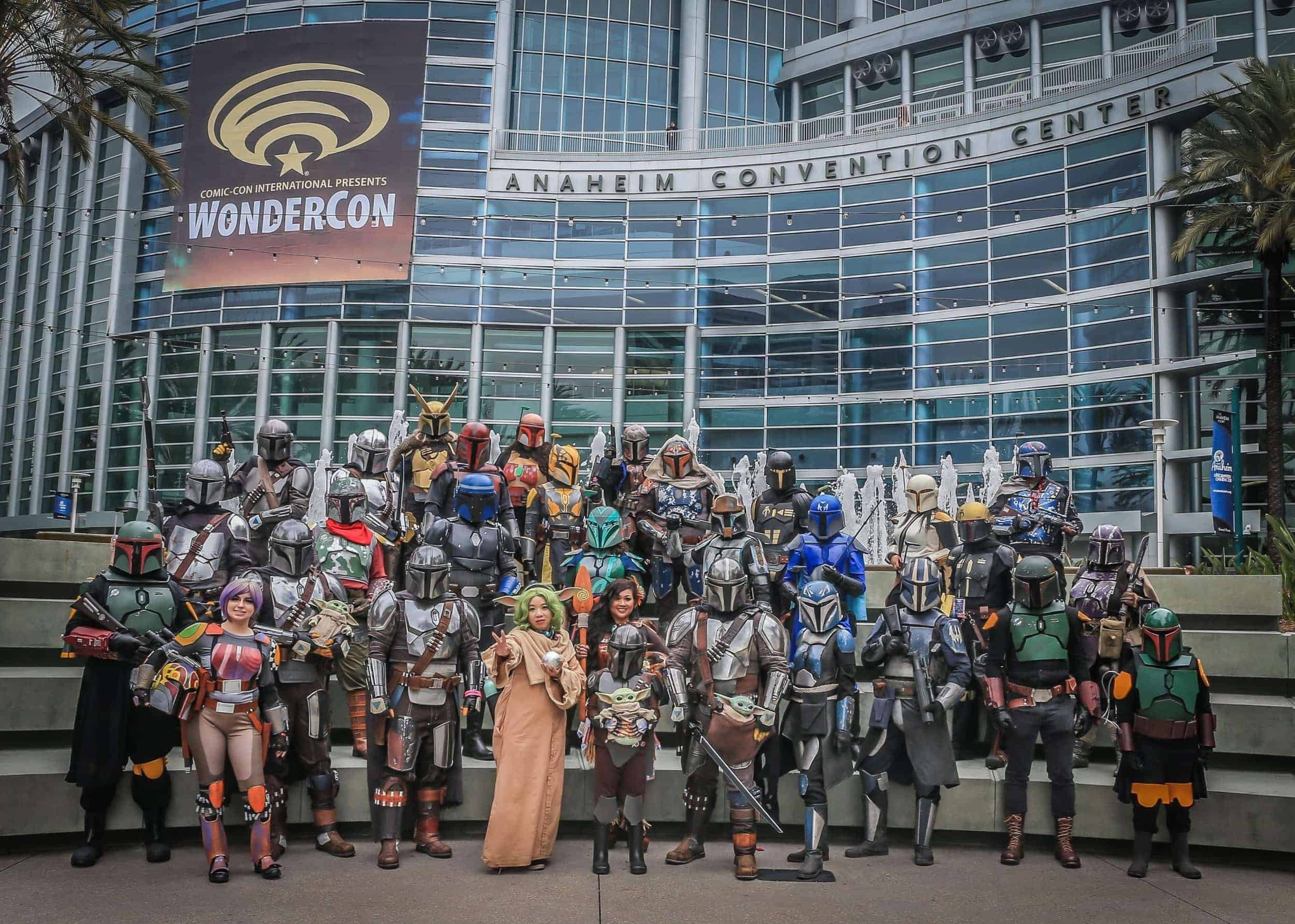 A large group of Star Wars Mandalorian and Boba Fett cosplayers posing outside the Anaheim Convention Center during WonderCon
