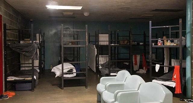 Empty beds sit in a dark, empty room of the current Whatcom County jail.