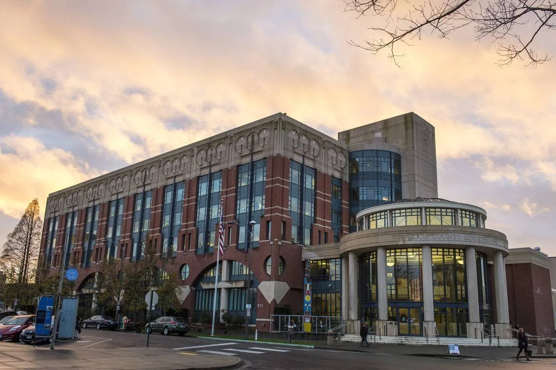 The exterior of the Whatcom County Courthouse at the end of a cloudy day.