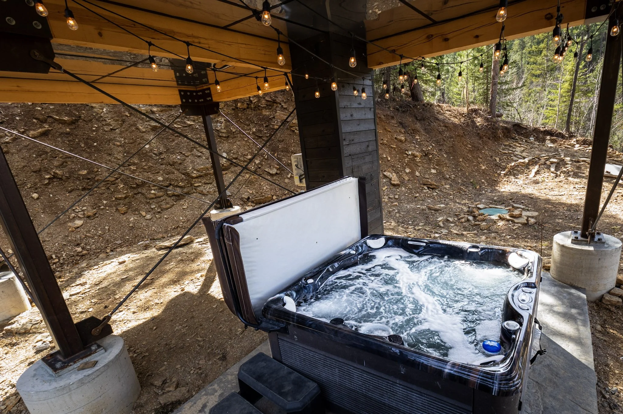 Black Hills cabin hot tub at Black Steel Pines Cabin in Lead South Dakota with forest surrounding