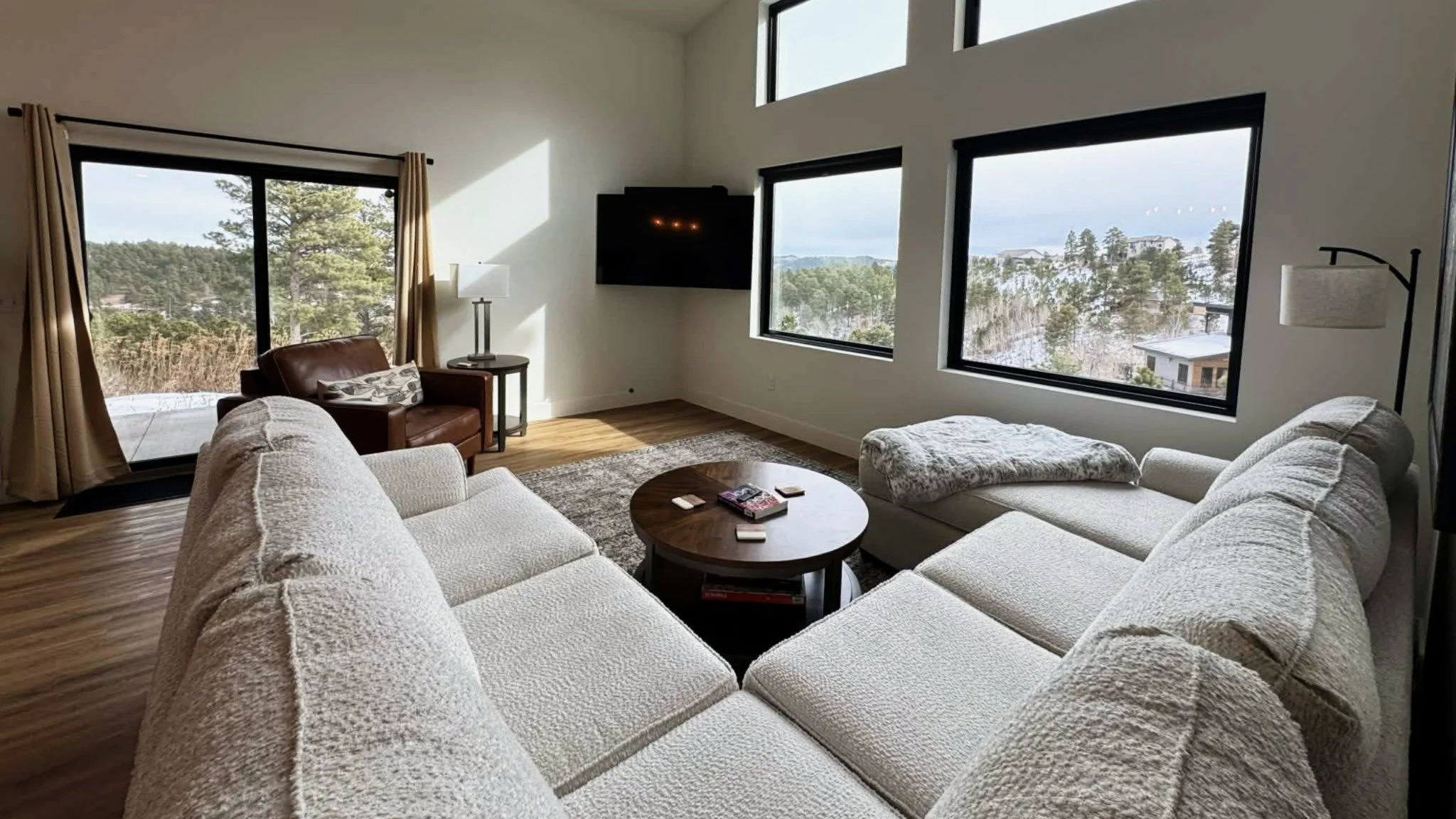 Modern living room with large windows and scenic Black Hills views at The Overlook on Mountain View vacation rental near Deadwood South Dakota
