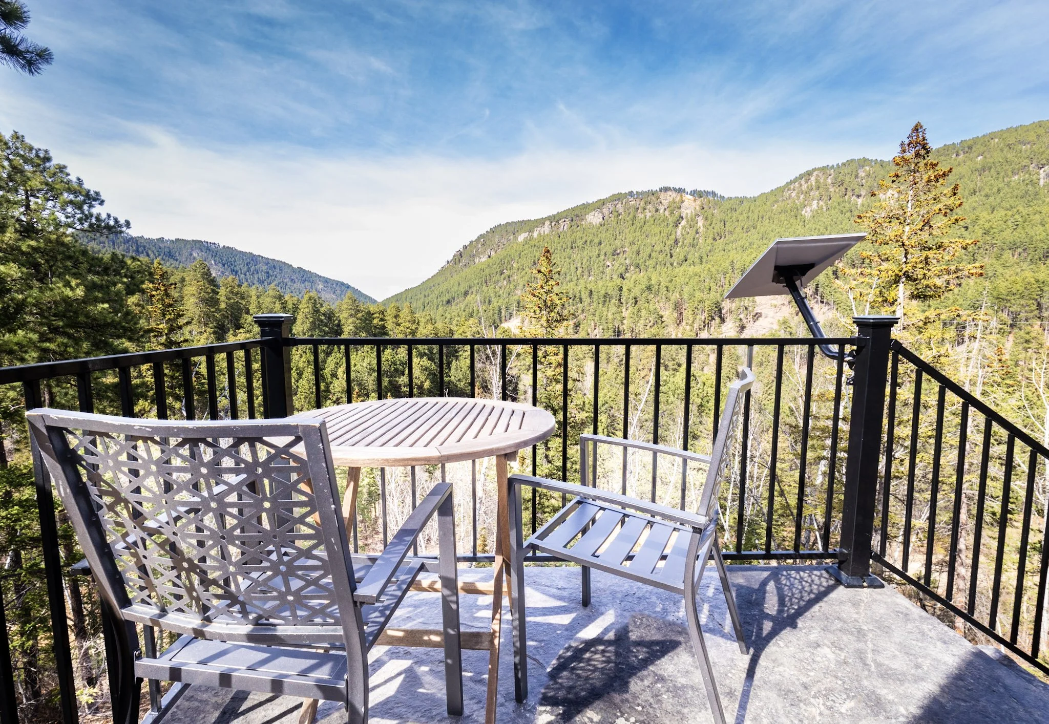 Steel Pines Cabin upper deck with outdoor seating and panoramic Black Hills mountain views in Lead South Dakota
