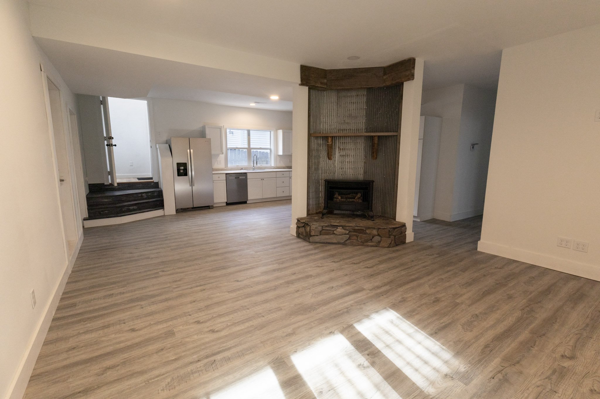 living room fireplace looking into the kitchen at a lead sd apartment rental on Railroad Ave