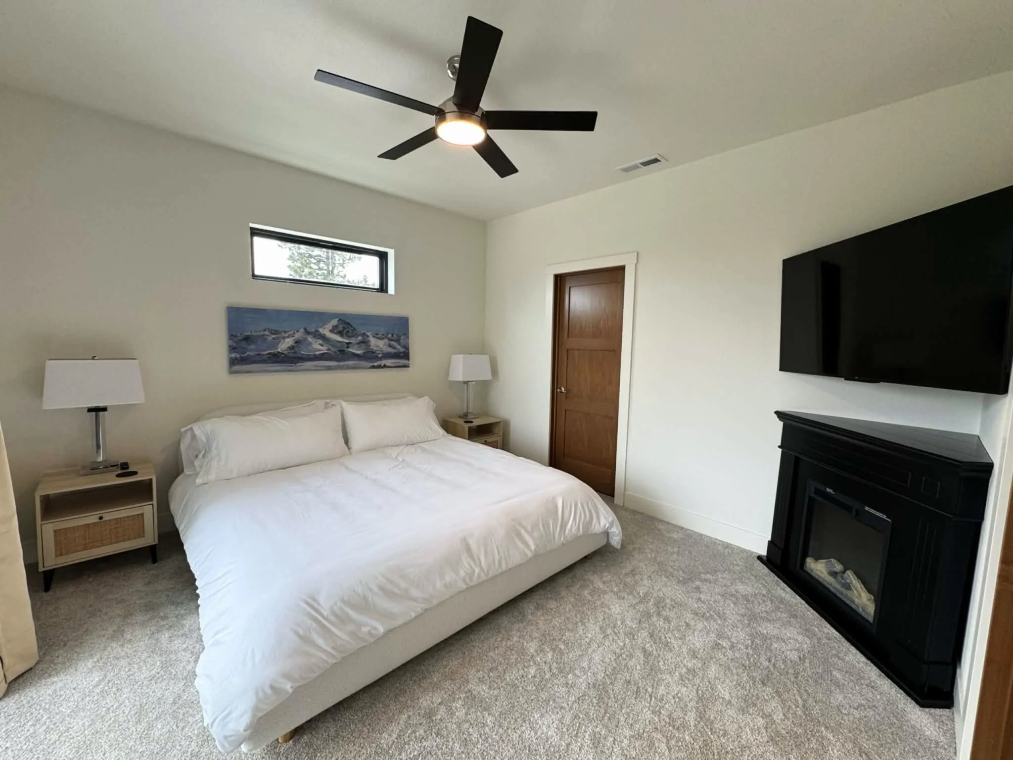 Comfortable primary bedroom with fireplace at The Overlook on Mountain View vacation home in the Northern Black Hills