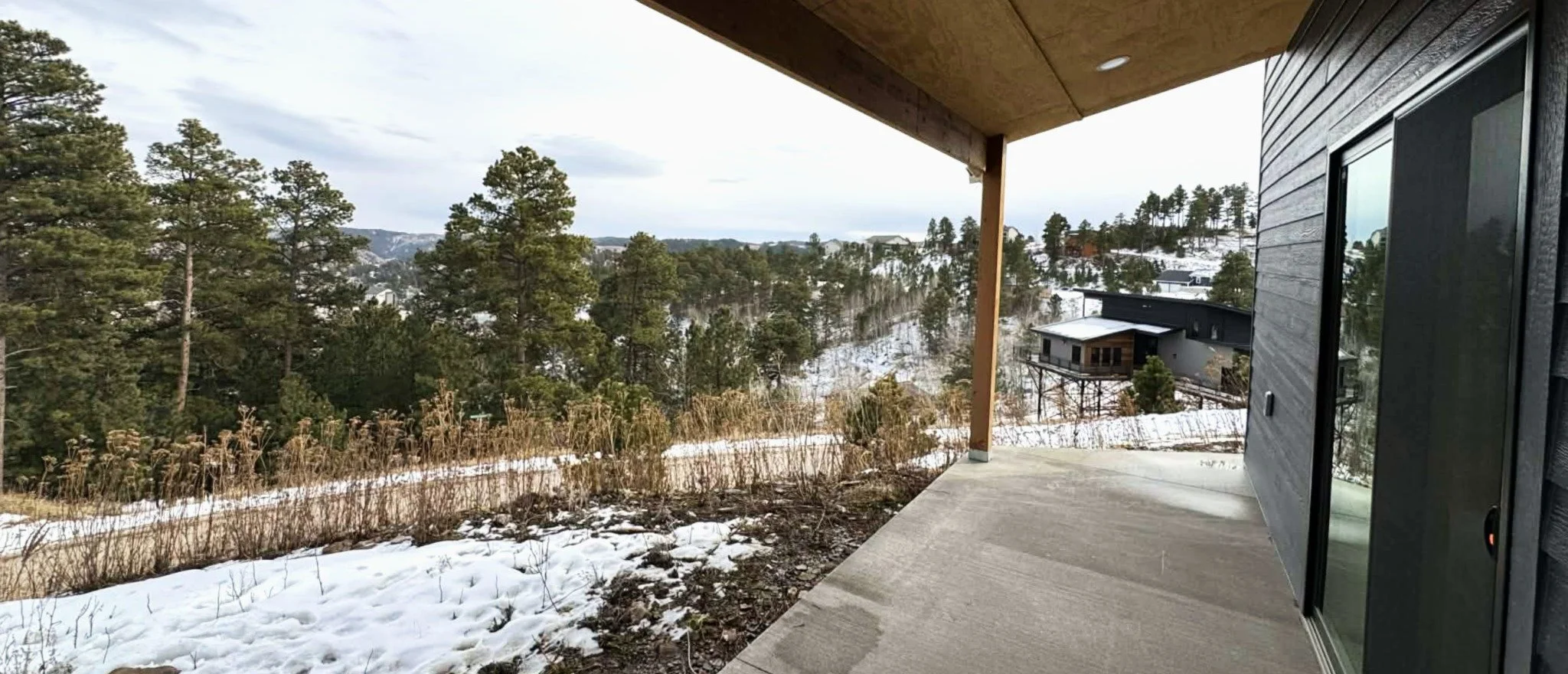Covered deck overlooking scenic Northern Black Hills landscape at The Overlook on Mountain View near Deadwood South Dakota